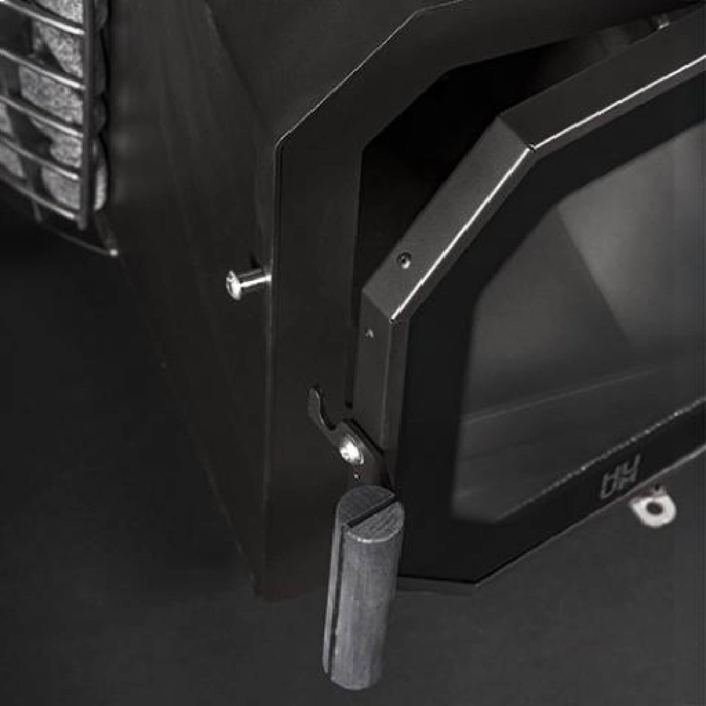 Close view of the firebox door handle on the Huum Hive Flow LS stove