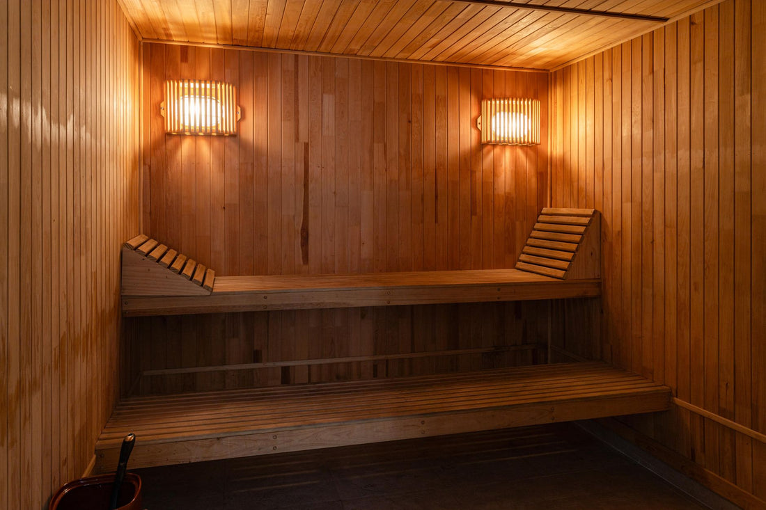 Warm wooden home sauna interior with tiered benches and soft lighting, the kind of compact model portable sauna buyers compare