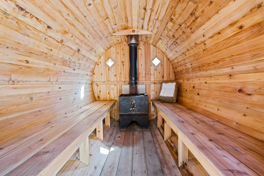 Warm wooden sauna interior with bench seating and a stone heater