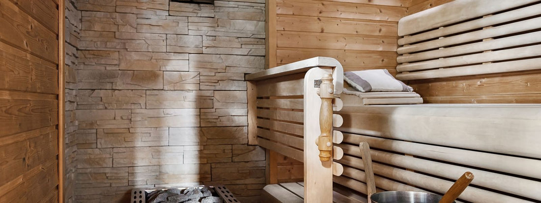 Two person infrared sauna cabin interior with wooden benches and a heater