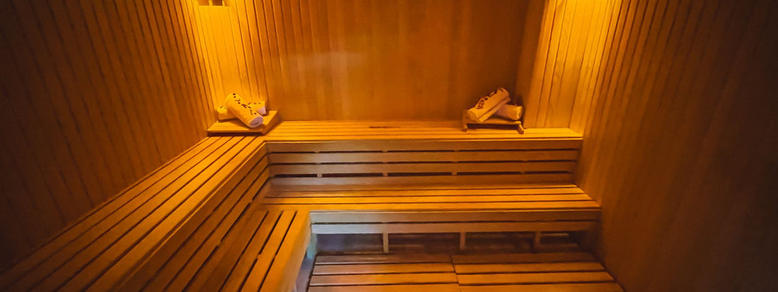 Compact cozy one person infrared sauna interior with warm wood and lighting
