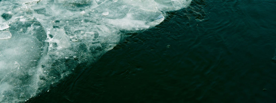 Ice forming on chilled water, illustrating the cold a cold plunge chiller maintains