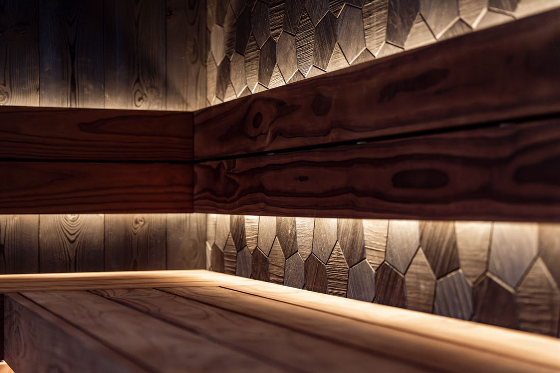 Warm modern sauna interior with cedar benches and LED accent lighting, illustrating gentle low-heat sauna use for sensitive skin