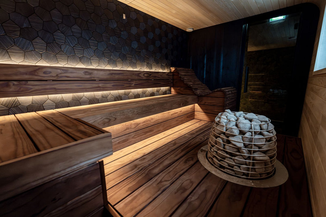 Warm cedar home sauna interior with tiered bench seating and soft accent lighting