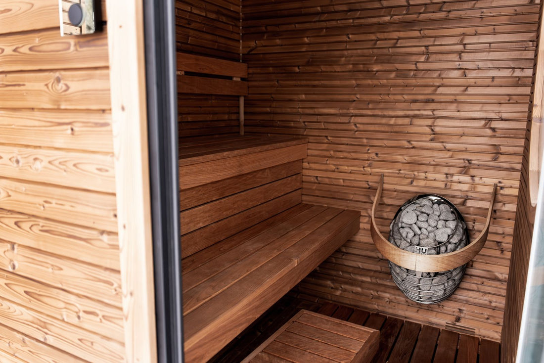Modern wooden infrared sauna interior with heater and benches