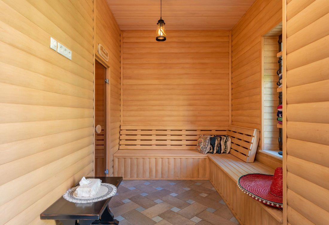 Warm light-cedar home sauna interior with wooden benches, a calm space for a consistent sauna and recovery routine