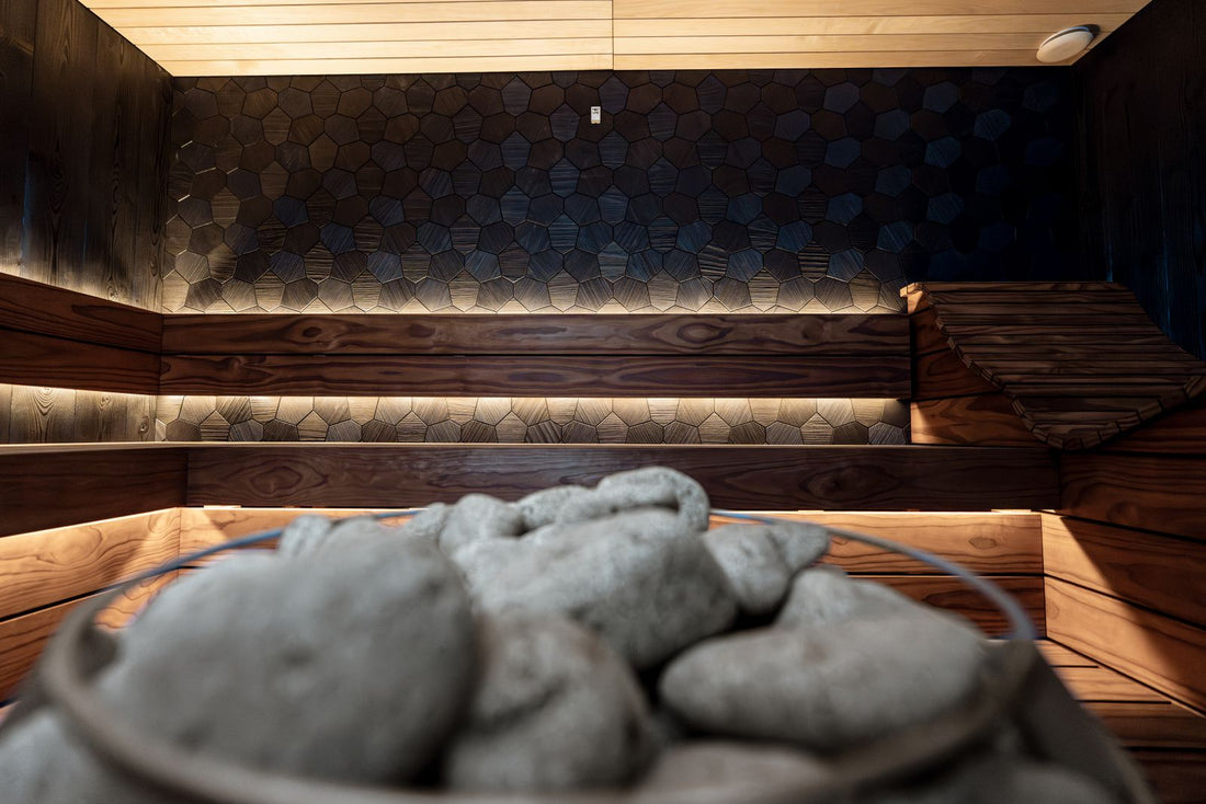 Contemporary indoor home sauna with wooden benches and warm ambient lighting