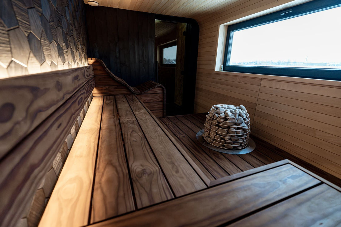 Compact modern indoor sauna with wood paneling and a window