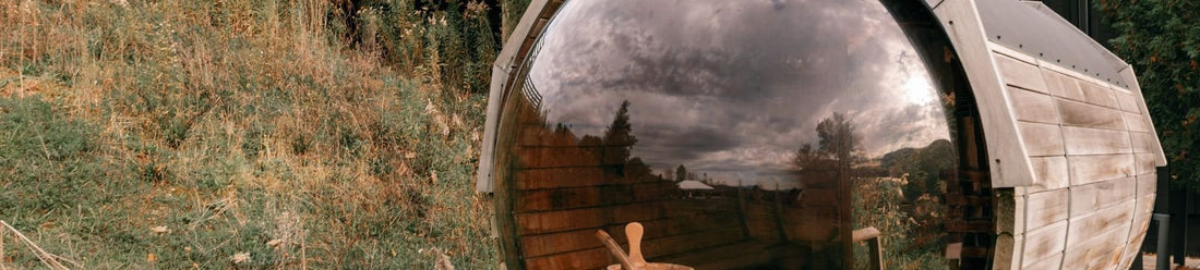 Outdoor wooden barrel sauna in a natural backyard, an example of the best outdoor sauna