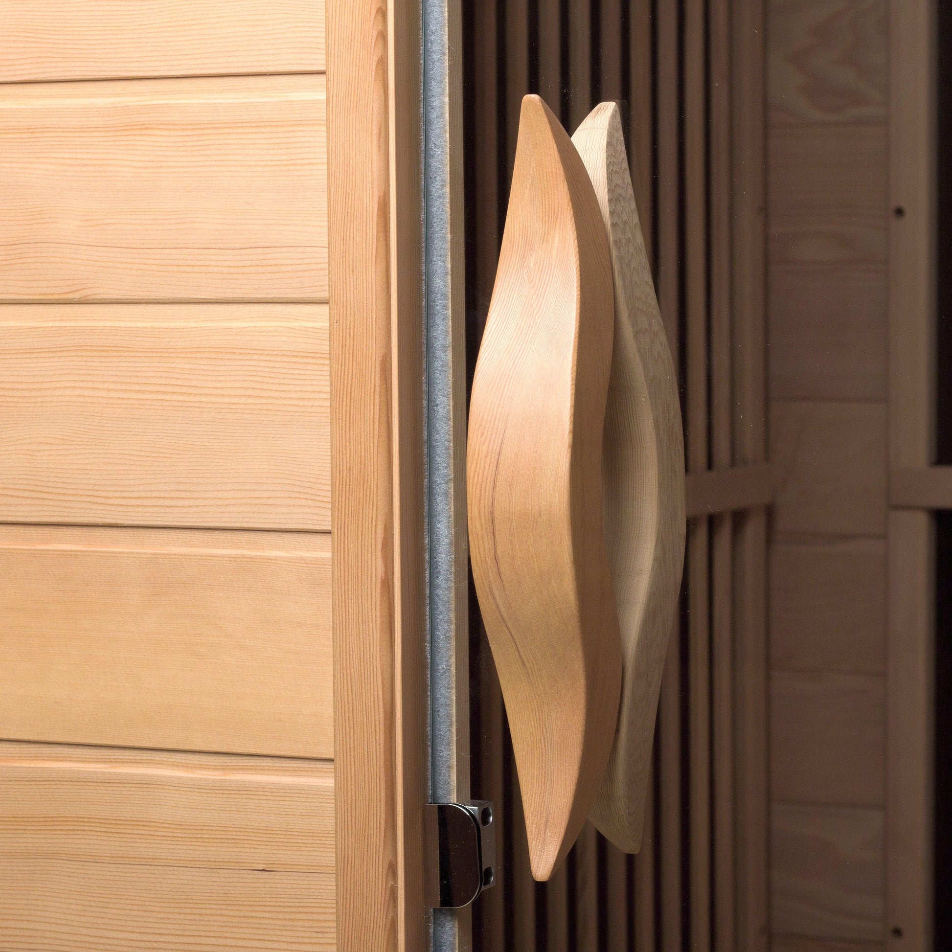 Wooden backrest and towel hook detail inside the hemlock infrared sauna
