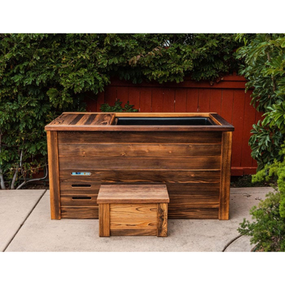 Kooru cold plunge tub installed on a patio against a hedge