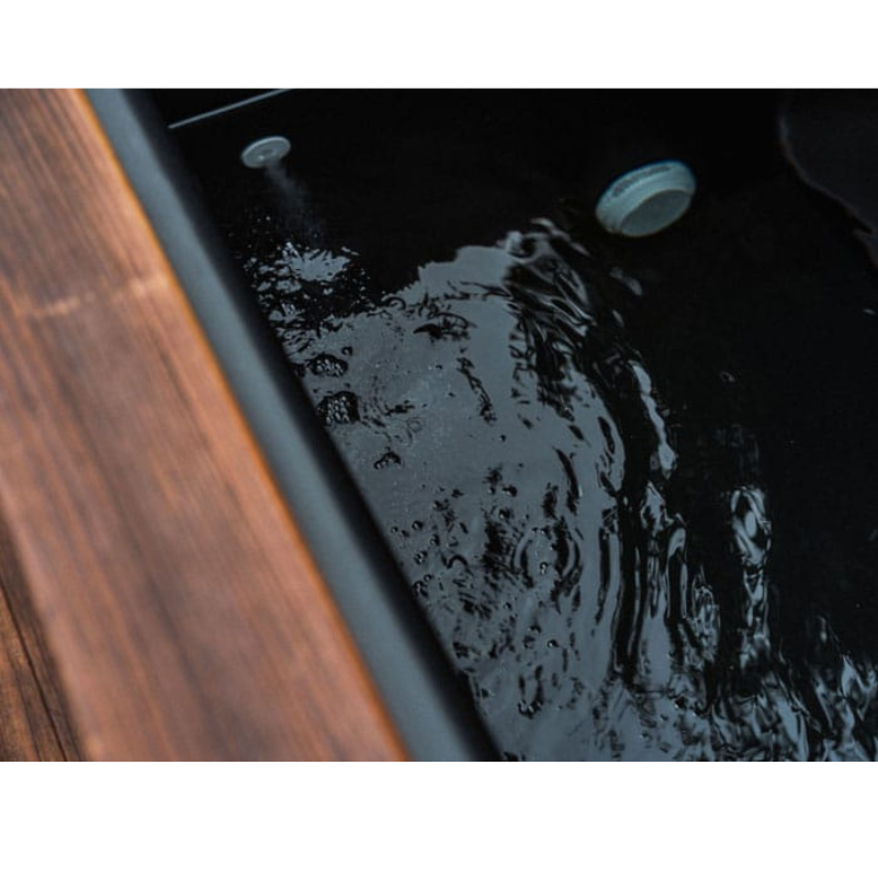 Water circulating inside the black liner of the Kooru cold plunge tub