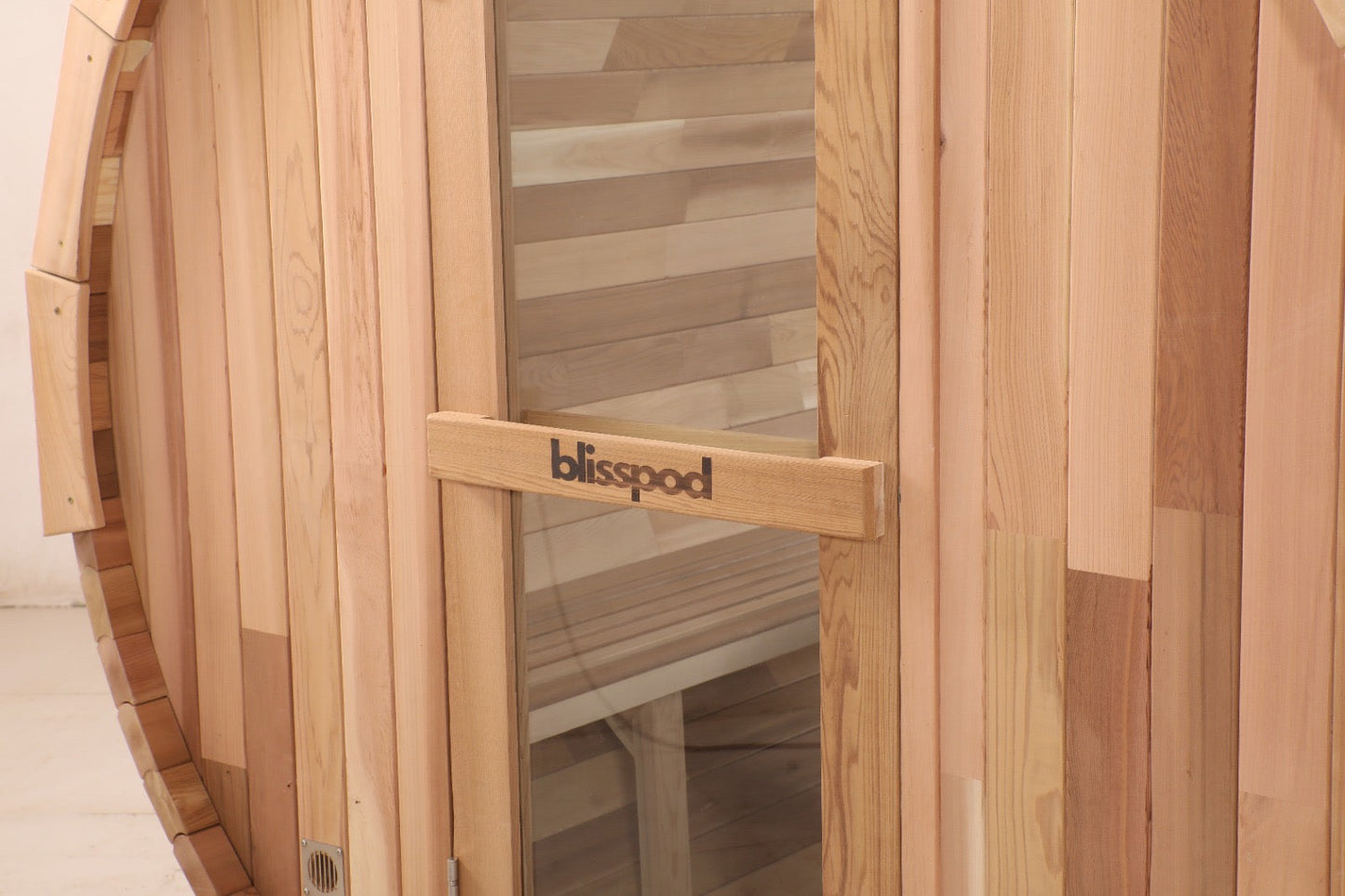 Glass door and cedar frame on the front of the Blisspod Prague barrel sauna