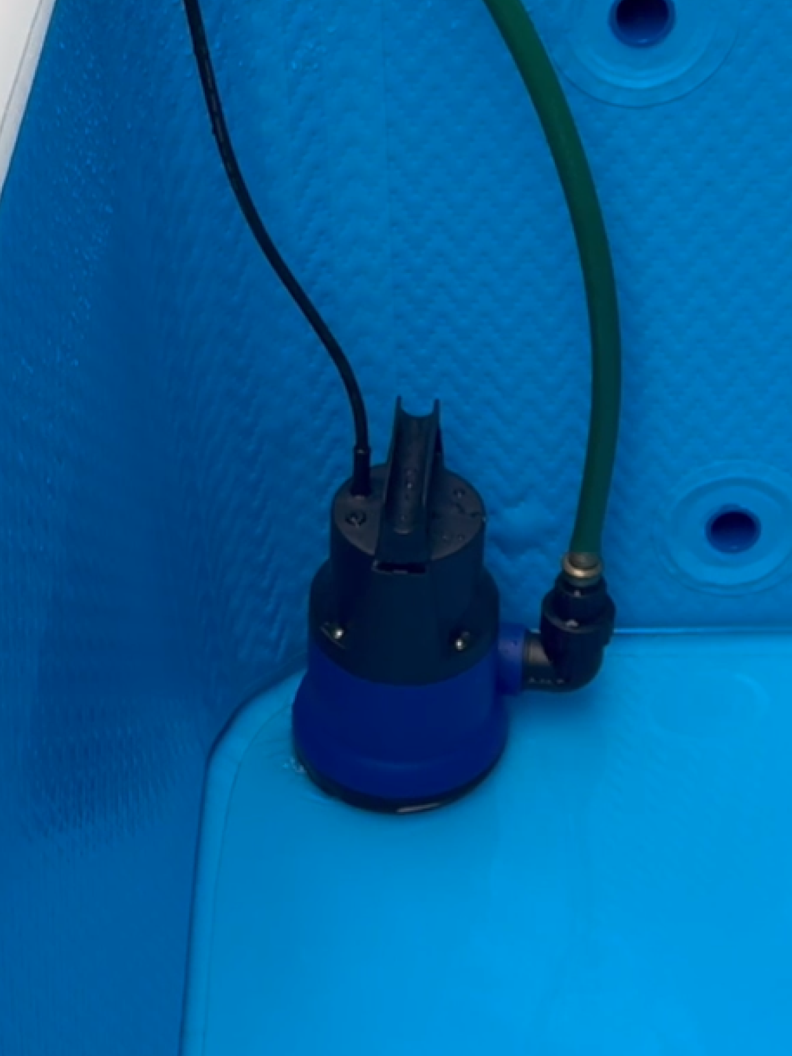 RevX drain pump connected and draining a cold plunge tub
