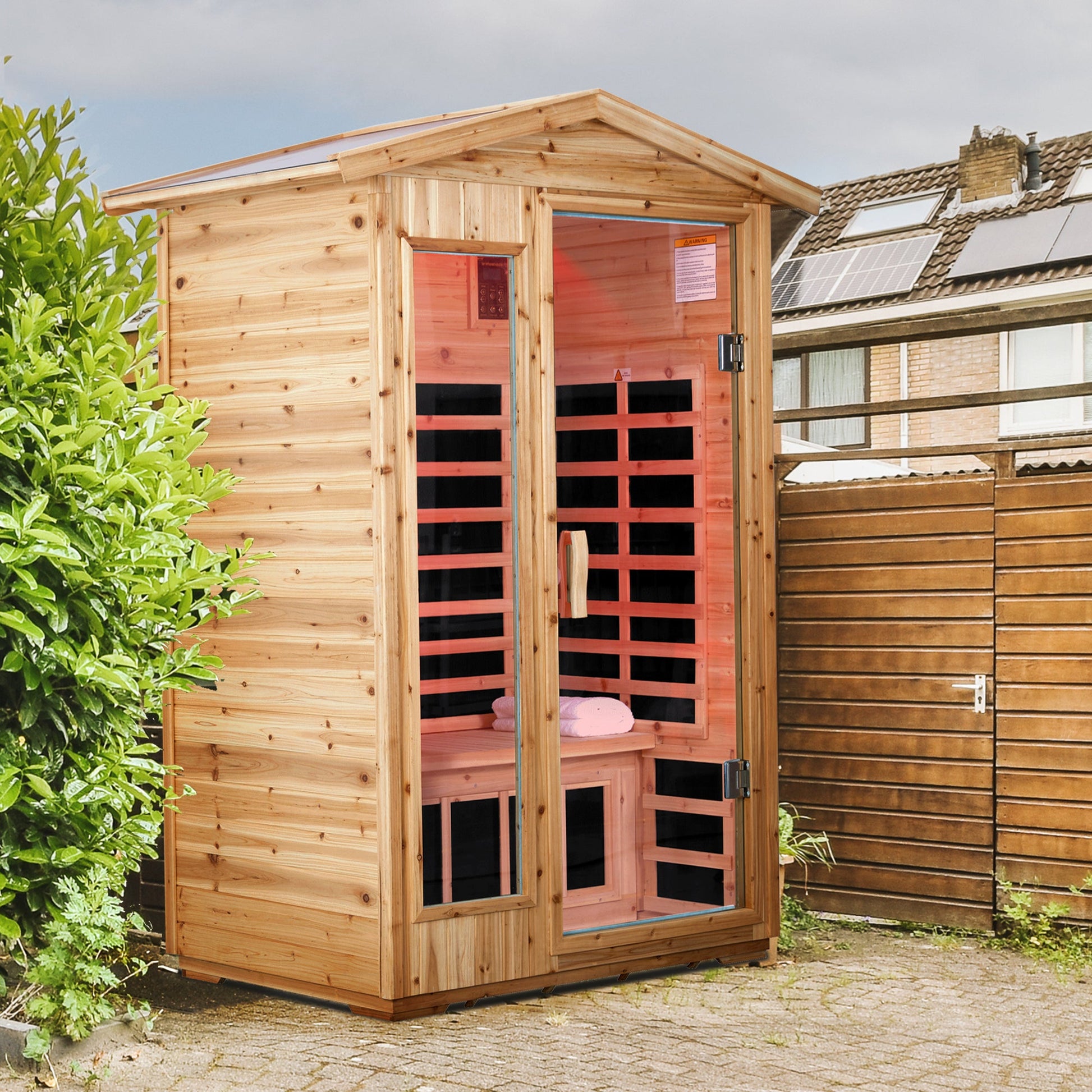 Two person old fir outdoor sauna room installed on a paved backyard patio