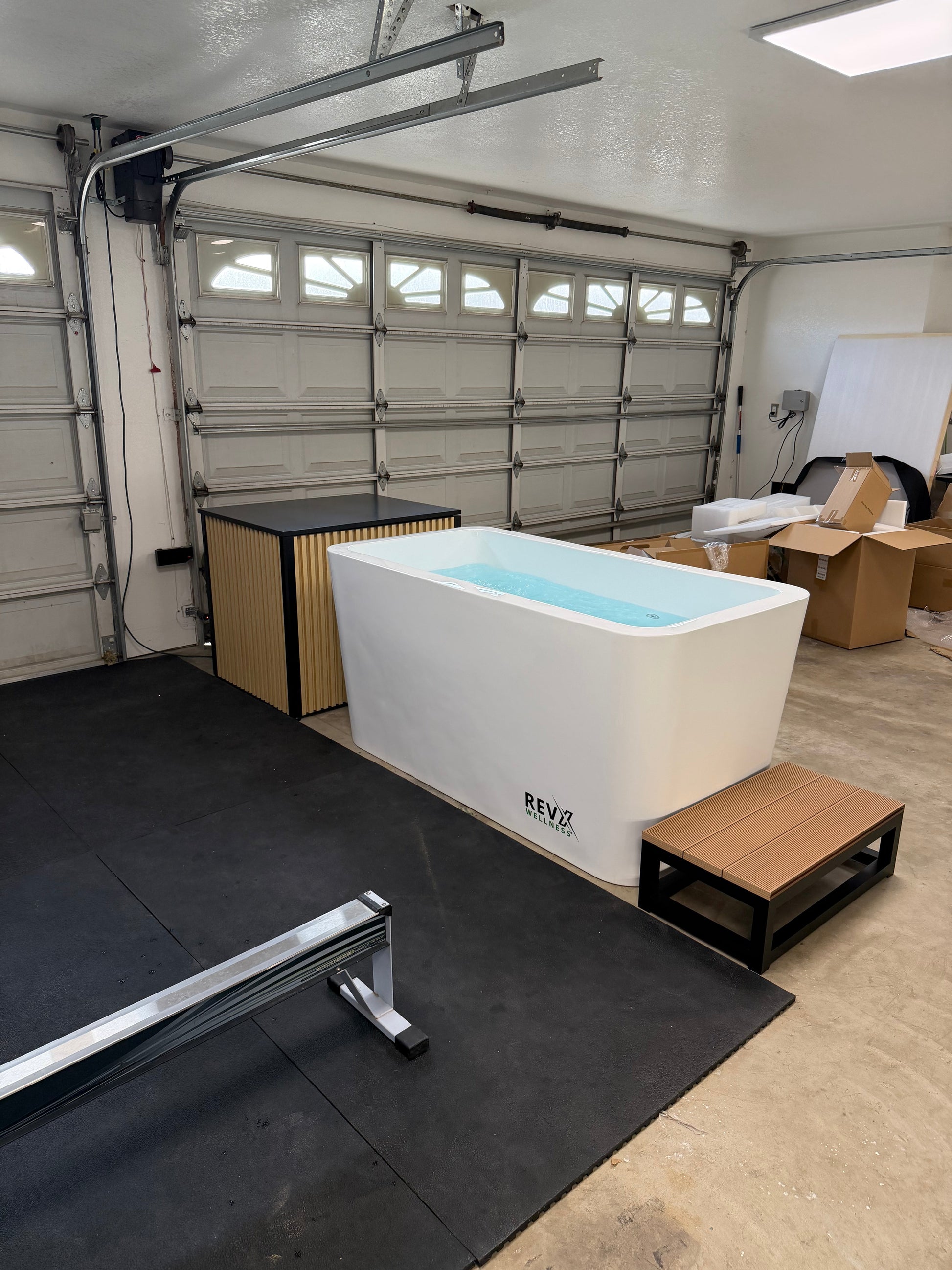 RevX cold plunge system installed with the chiller cabinet alongside the tub