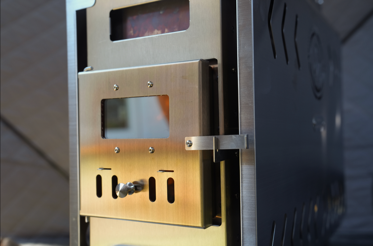 Firebox door of the North Shore Sauna portable stainless sauna tent wood stove