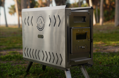 Brushed SS304 stainless steel portable sauna tent wood stove with chimney collar and folding legs, North Shore Sauna, shown outdoors