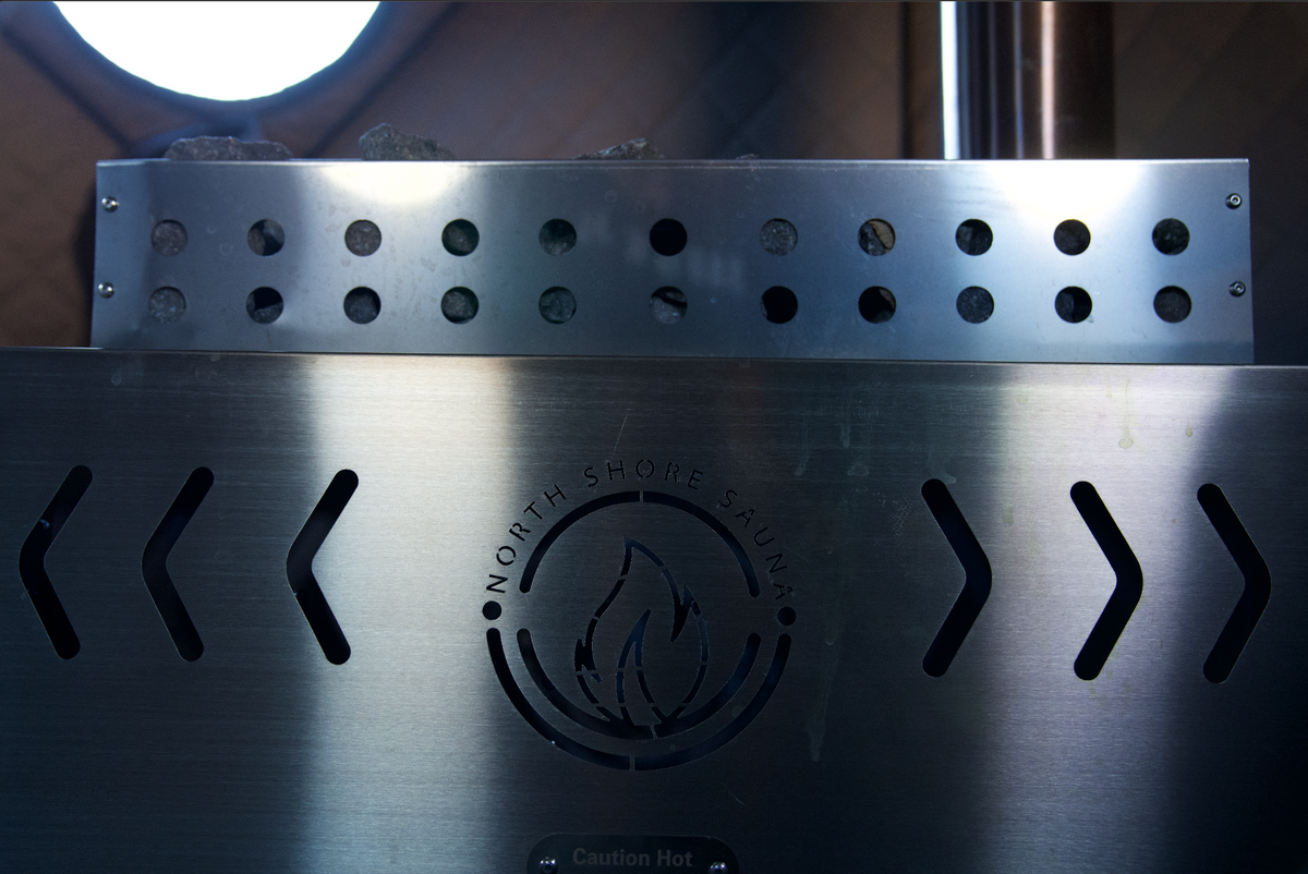 Firebox of the North Shore Sauna XL sauna tent wood stove with a wood fire burning