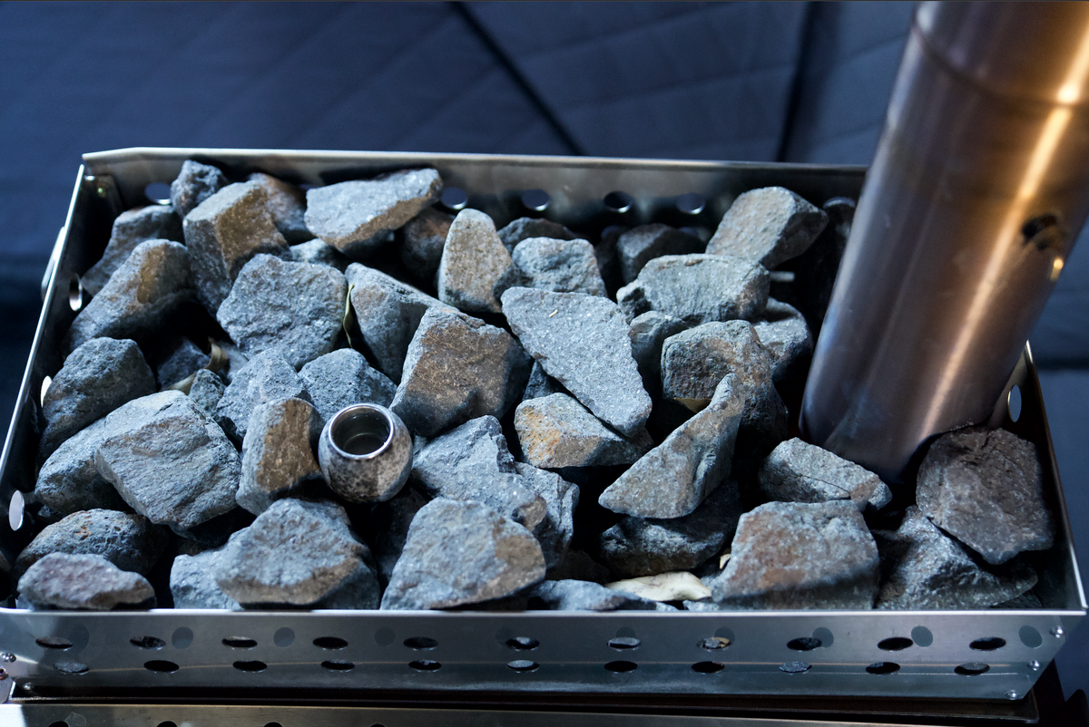 Sauna stones loaded on the North Shore Sauna XL sauna tent wood stove