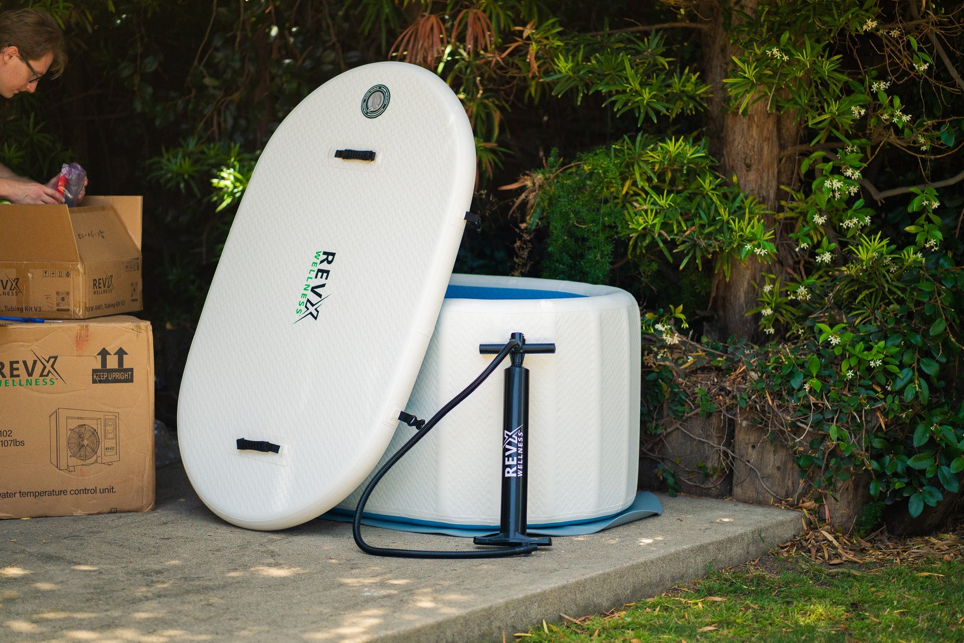 RevX Inflatable Classic being unboxed outdoors with the lid and manual air pump