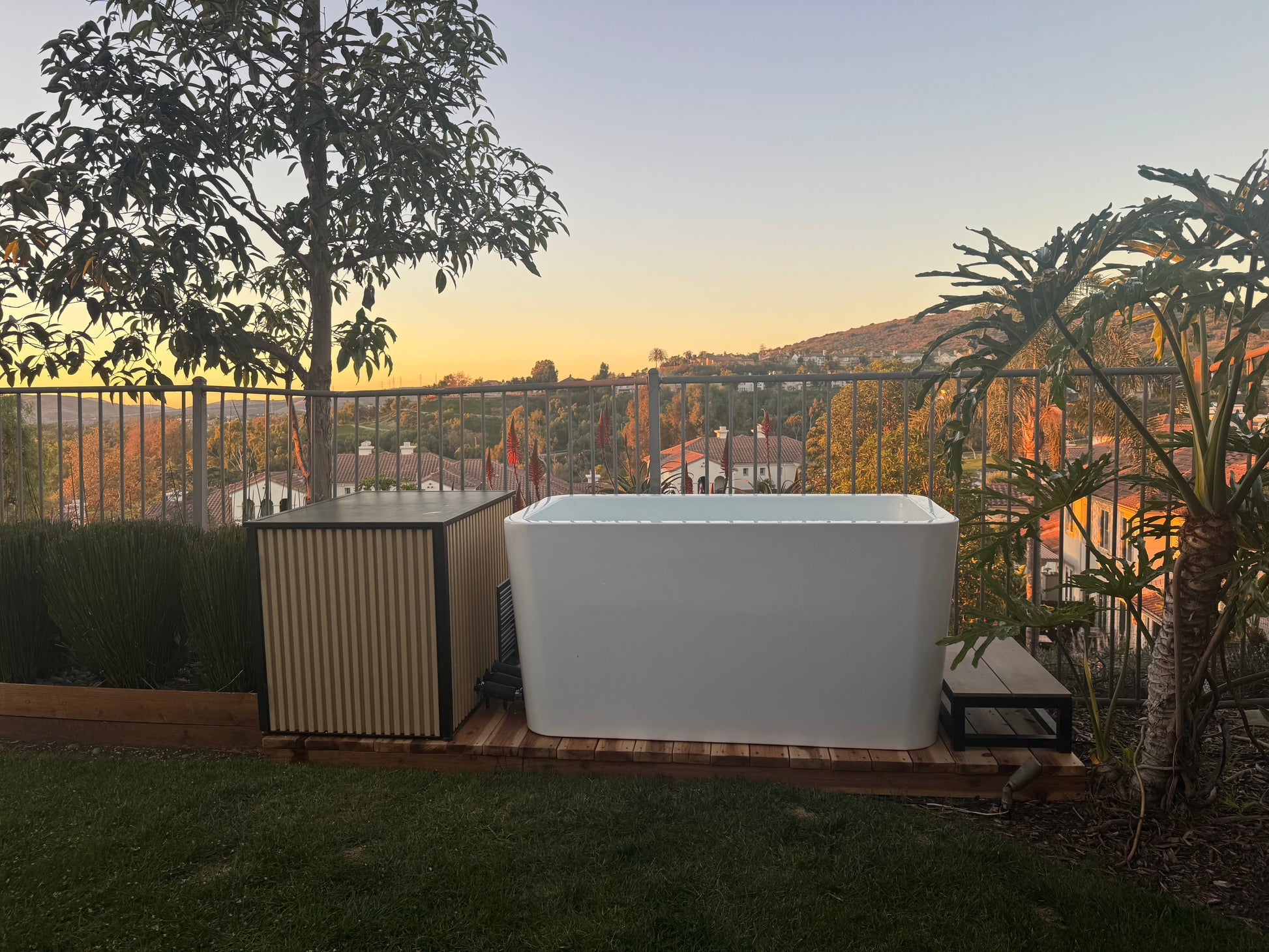 RevX X Tub cold plunge and chiller cabinet on a backyard deck at sunset