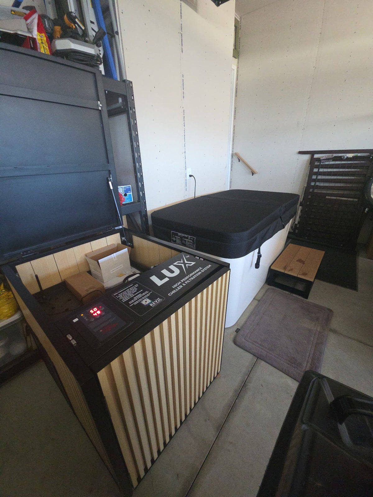 RevX X Tub and LUX chiller cabinet unpacked in a garage before installation