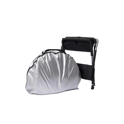 Relax Black Pro sauna packed into its silver carry bag beside the folding chair