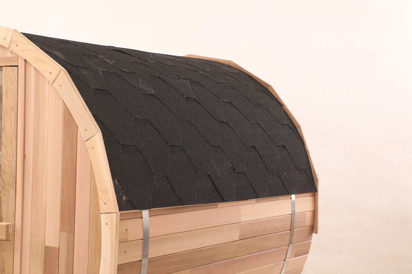 Asphalt shingle roof and steel banding on the Blisspod Prague cedar barrel sauna