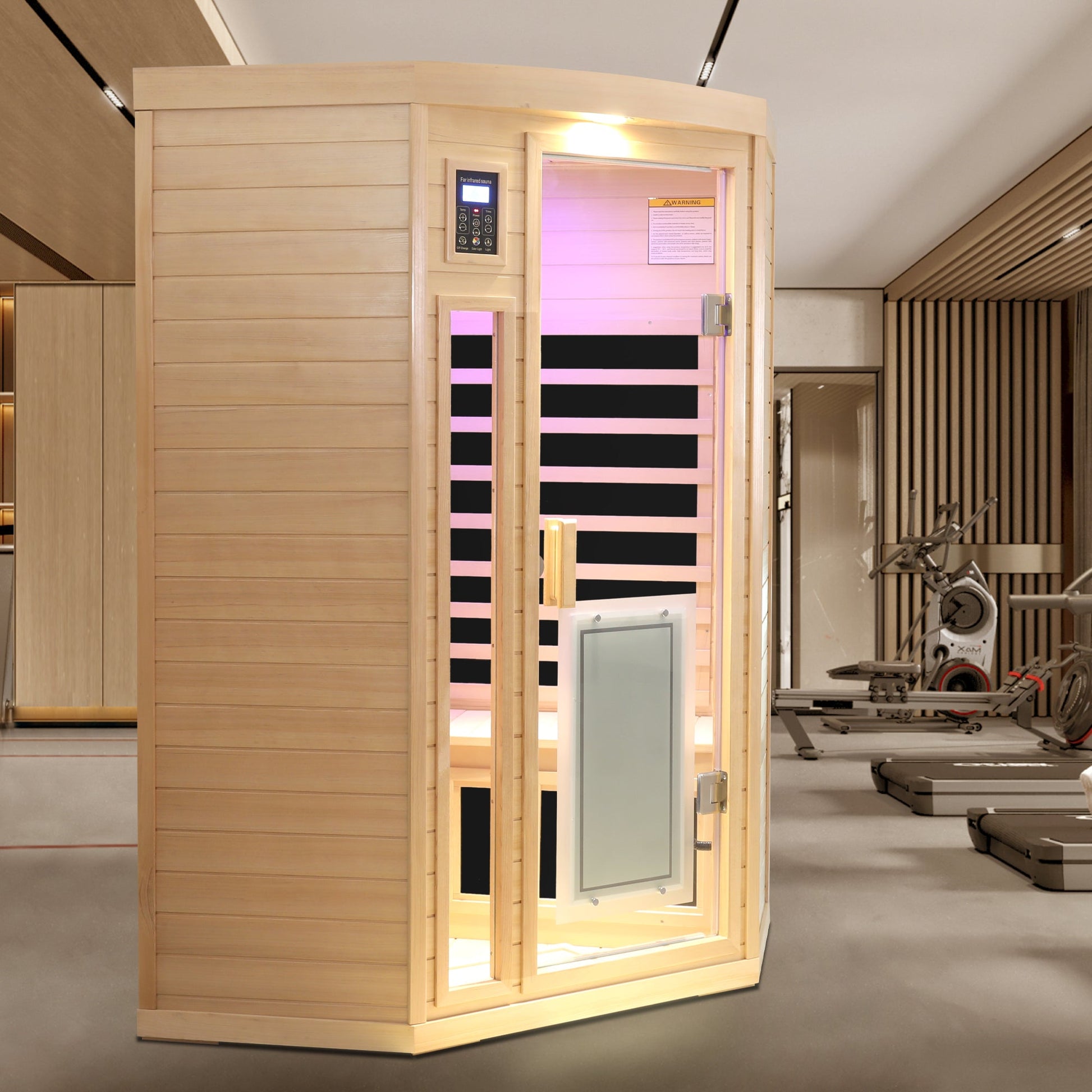 Low EMF hemlock corner sauna room installed in a home gym beside exercise equipment