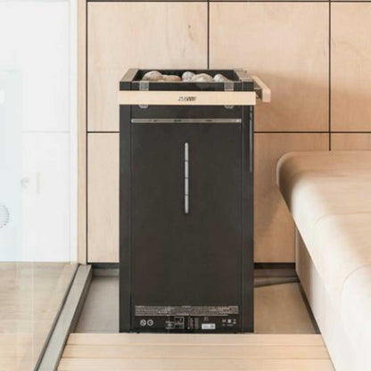 Harvia Virta Combi heater installed in a sauna room next to a wooden bench